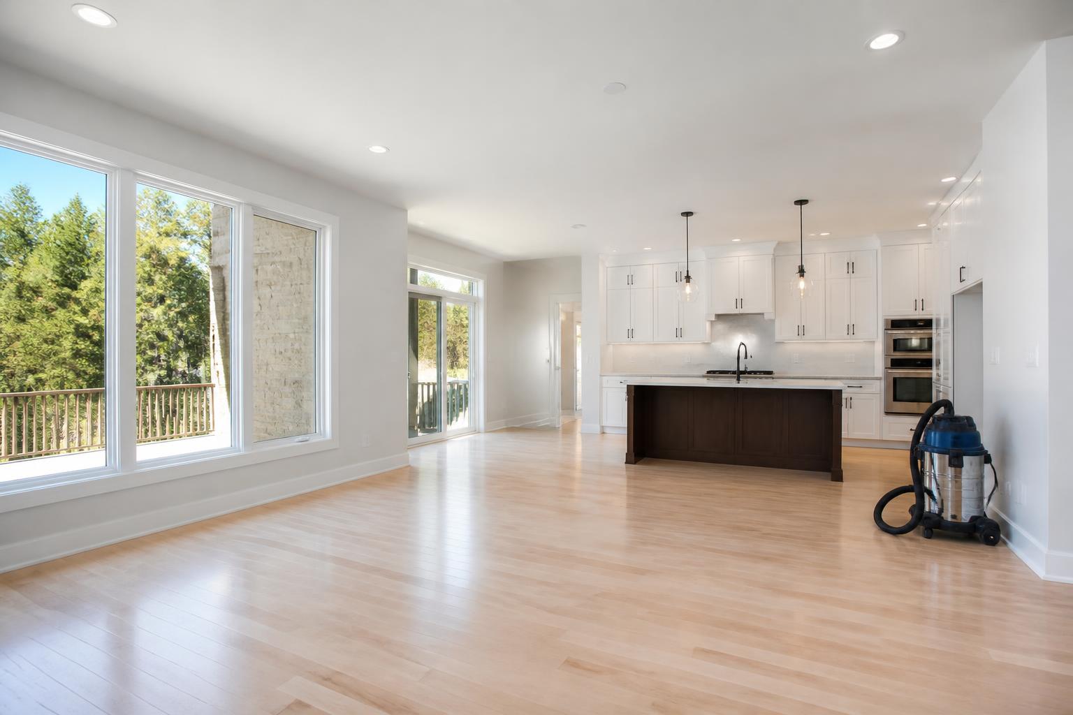 Newly built home interior with pristine floors, windows and a professional vacuum